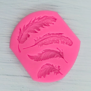 Macro detail of pink feather silicone mold with four distinct textured leaf patterns