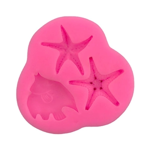 Pink silicone mold featuring starfish and fish shapes for ocean cake decoration