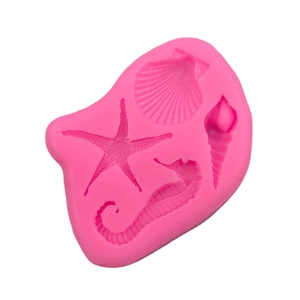 Pink silicone mold featuring seahorse, starfish, and seashell shapes for fondant or cake decor