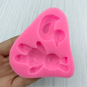 Pink silicone mold featuring cute cartoon rabbit and duck shapes for cake decorating