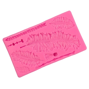 Pink silicone mold featuring various large feather and leaf texture patterns for DIY baking