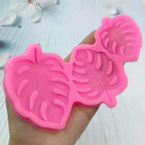 Pink monstera leaf silicone mold in three sizes for DIY cake decorating and crafts