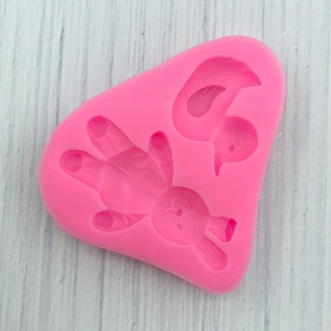 Detail of pink silicone mold with cute bunny and duck shapes for DIY cake fondant and soap