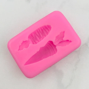 Macro detail of pink silicone mold featuring two carrot shapes for DIY cake decorating