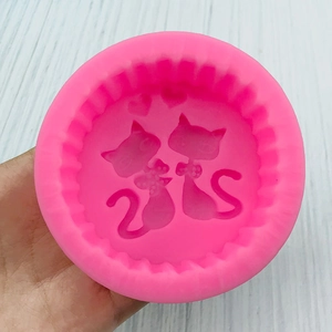 Pink round silicone mold featuring a cute twin cat design for DIY cake decorating and crafts