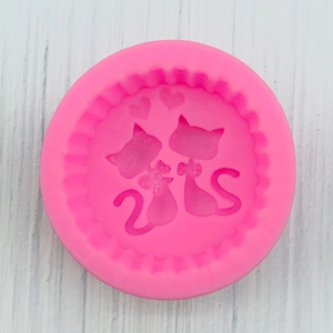 Detailed top view of a pink silicone mold featuring a cat and heart relief design
