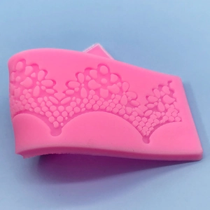 Pink silicone lace fondant mold with intricate flower patterns for DIY cake border decorating