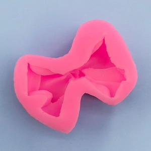 Macro detail of 3D bow silicone mold with precise texture for DIY fondant cake baking