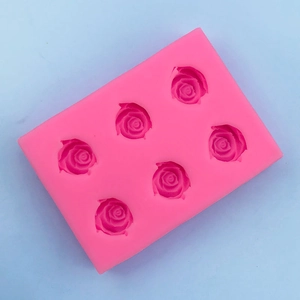 Top-down view of a bright pink 6-cavity rose flower silicone mold for chocolate and fondant