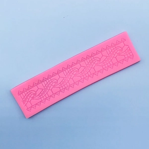 Macro detail of pink lace silicone mold featuring intricate geometric and floral vine textures