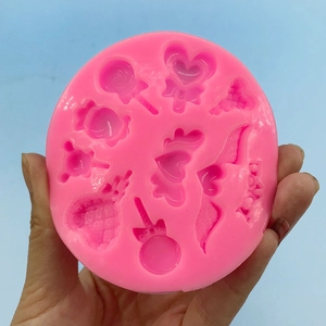 Rosa Silikonform mit Herz, Flügel und Süßigkeiten für DIY-Fondant oder Schokolade