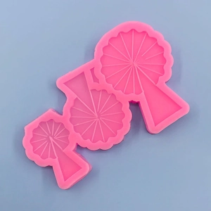 Detail view of pink silicone mold with three sizes of ginkgo leaf cavities for DIY crafts