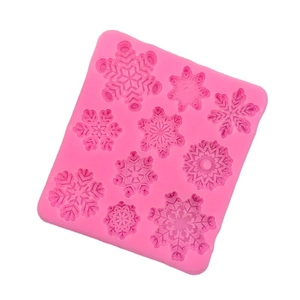 Pink silicone mold featuring nine snowflake shapes for fondant and chocolate baking