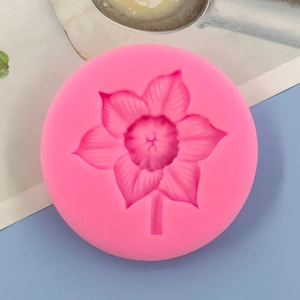 Detailed macro view of pink silicone mold featuring intricate floral petal textures for baking