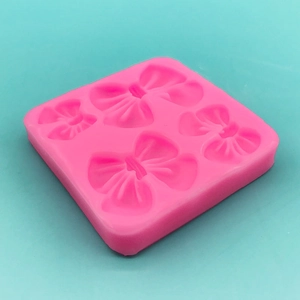 Stampo in silicone rosa alimentare con quattro fiocchi per torte e cioccolato
