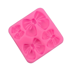 Stampo in silicone rosa con quattro forme di fiocco per fondente per torte e cioccolato