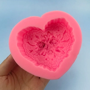 Pink heart-shaped silicone mold with floral rose relief for cake decor and soap making