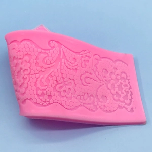 Pink lace flower silicone mold for DIY fondant and cake decoration on blue background