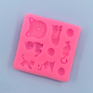 Pink silicone mold with various cat shapes and wool ball patterns for DIY cake decor