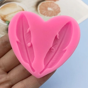 Pink heart-shaped silicone mold with feather texture for fondant and baking decoration
