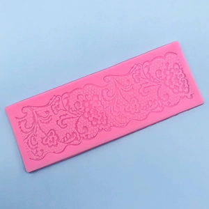Detailed macro view of pink silicone lace mold with intricate floral texture for fondant