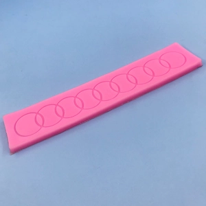 Pink silicone mold with interlocking circle pattern for DIY fondant cake decoration