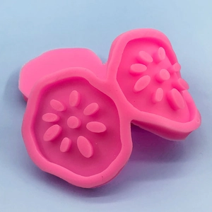 Pink lotus root vegetable silicone mold for ice cream and mousse on blue background