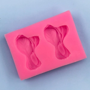 Detail of pink silicone mold with leaf patterns for fondant cake decoration and DIY crafts