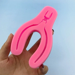 Pink silicone pliers mold for DIY fondant and soap craft on light blue background