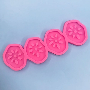 Detailed macro view of a 4-cavity pink lotus root silicone mold for DIY baking and mousse