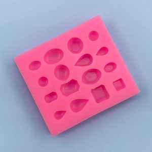 Detailed pink silicone mold with 16 geometric gem shapes for DIY jewelry and fondant art