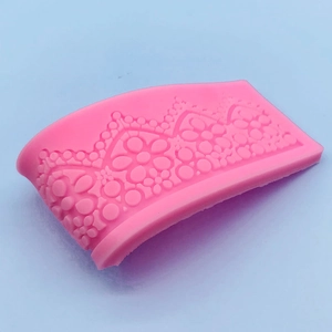 Pink silicone fondant mold featuring crown lace and floral patterns for cake decoration