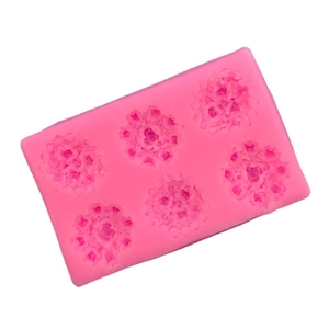 Pink silicone mold featuring six detailed rose flower cavities for DIY cake decorating
