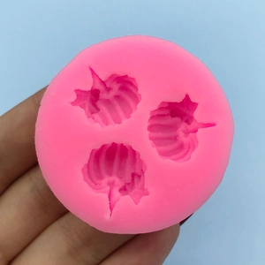 Pink silicone pumpkin mold with three cavities for DIY Halloween baking and cake decorating