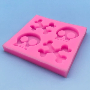 Pink silicone skull and crossbones DIY mold for Halloween cake decorating and chocolate
