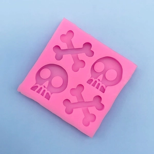 Close-up of pink silicone skull and bones mold for Halloween chocolate and fondant