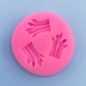 Pink silicone mold with three animal paw print cavities for chocolate and baking