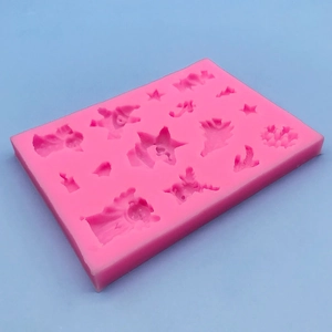 Pink Christmas silicone mold featuring stars, trees and reindeer for holiday baking