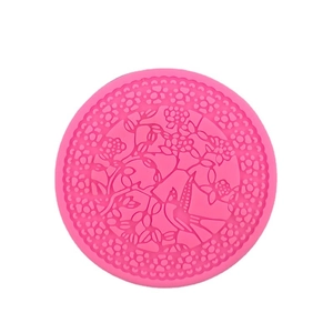 Pink round silicone mold featuring intricate floral and bird embossed patterns for DIY baking