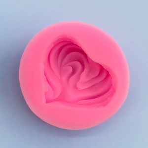 Top view of pink silicone heart mold with textured layers for soap and candle making