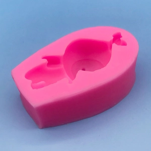 Pink whale-shaped silicone mold for making resin crafts and scented candles on blue background