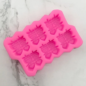 Pink silicone mold featuring six cavities of traditional Chinese double happiness symbols