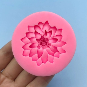 Pink lotus flower silicone mold for baking, fondant, and candle making, held by a hand