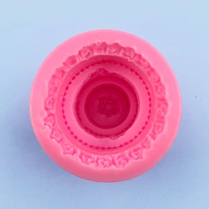 Macro detail of pink silicone mold featuring intricate 3D rose floral texture for baking