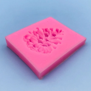 Pink silicone square mold with detailed pine cone patterns for cake decorating and DIY