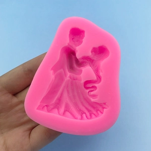 Pink silicone mold featuring a dancing bride and groom silhouette for wedding cake decorating