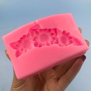 Pink silicone mold featuring three interconnected floral patterns for cake decorating and DIY