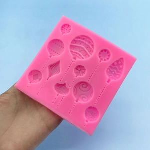 Pink silicone mold featuring various balloon patterns for festive cake decorating
