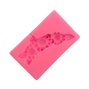 Pink silicone mold featuring three connected sunflower patterns for cake decoration