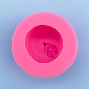 Macro detail of pink silicone mold featuring intricate 3D apple leaf textures for baking